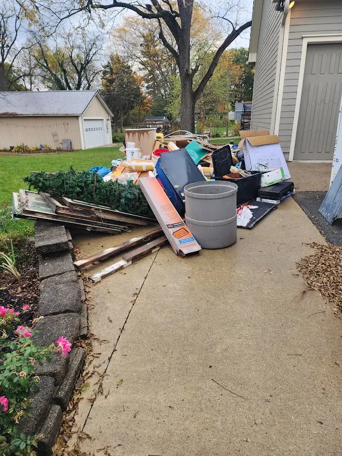 Dumpster being loaded with debris for 12 Yard Dumpster Rental in Louisville
